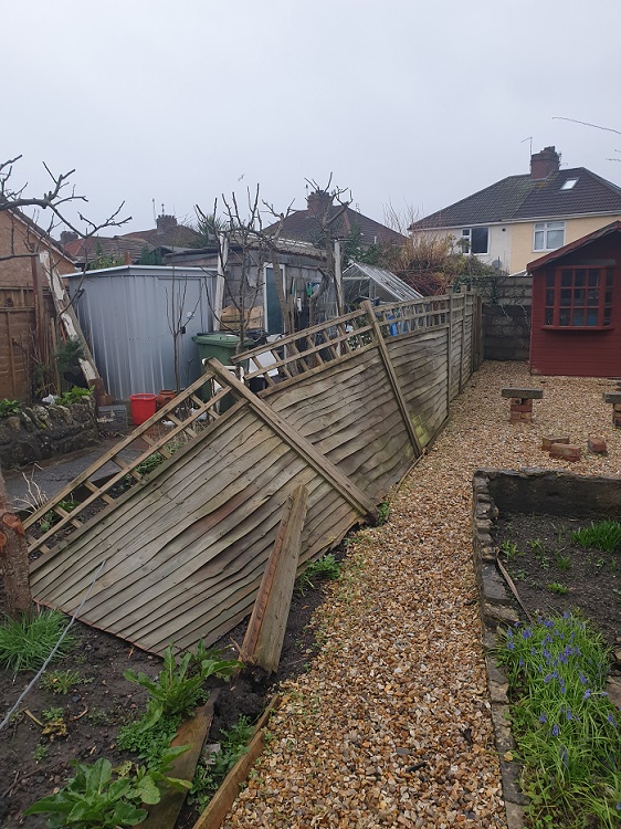 storm damaged fence before